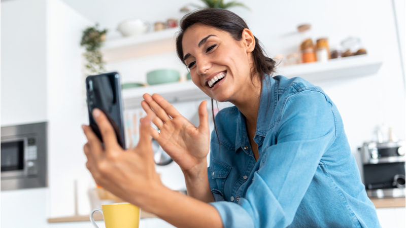 Cheerful woman smiling on a video call on her phone