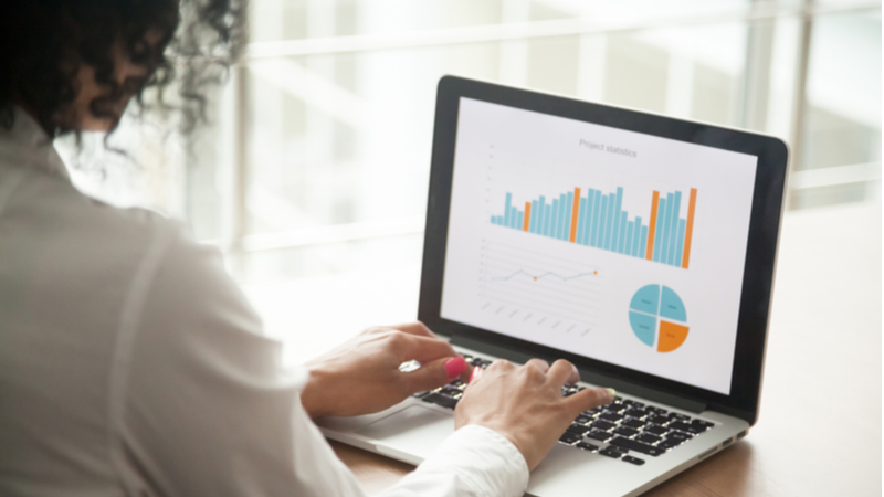 Woman analyzing statistics on laptop