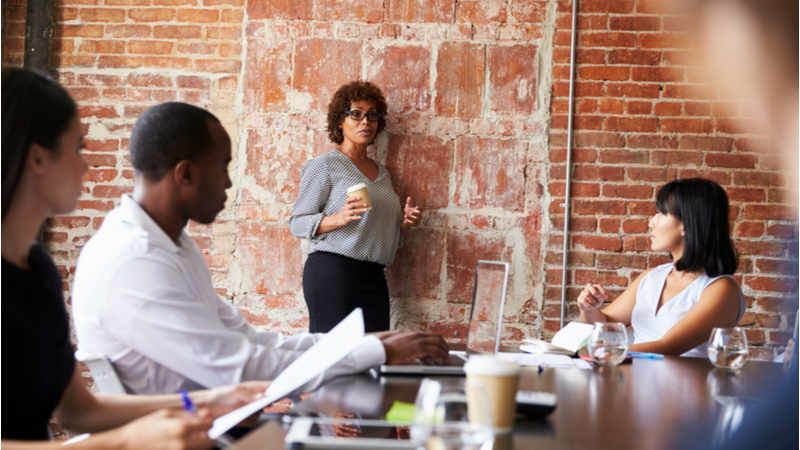 Woman explaining stuff to colleagues in a meeting