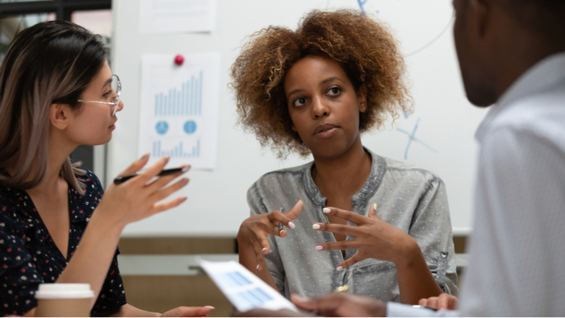 three people in business office planning details