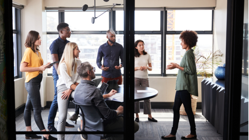 Woman holding a business meeting in front of coworkers